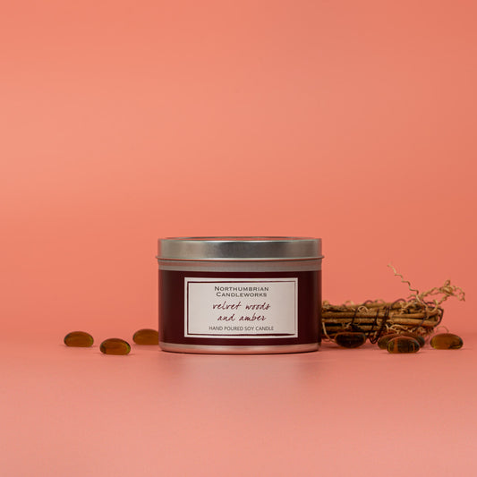 Velvet woods and amber soy wax candle in a tin