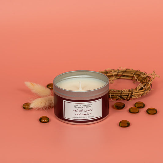 Velvet woods and amber soy wax candle in a tin